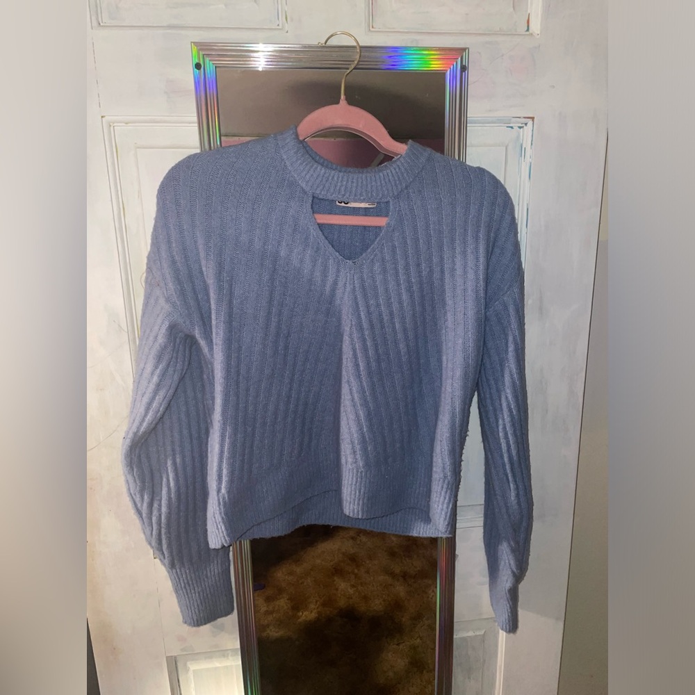 A cute blue sweater with a little neck cut out